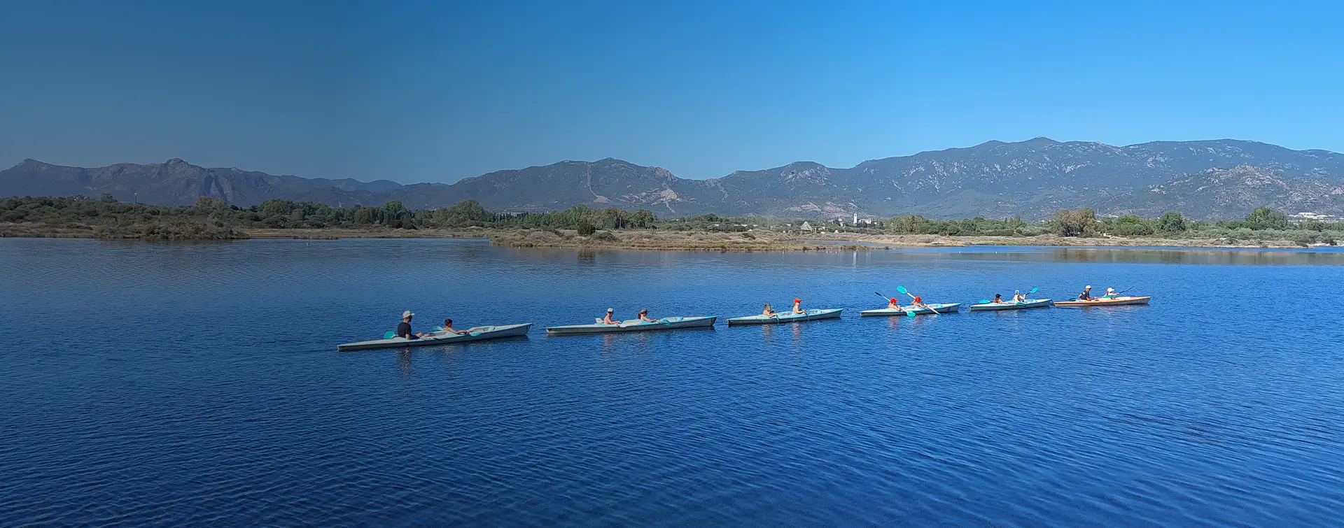 Gruppo di partecipanti durante escursioni nella laguna di Nora in canoa, tra le acque tranquille del parco lagunare Nora, immersi nell’ecosistema lagunare.